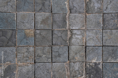 Old square concrete tiles background and wallpaper texture