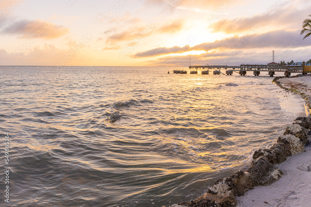 Naklejka premium Sunset on Hurricane Damaged Pier on Casa Marina Beach, Key West Florida, USA