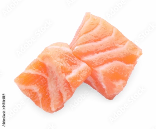 Pieces of fresh raw salmon on white background, top view