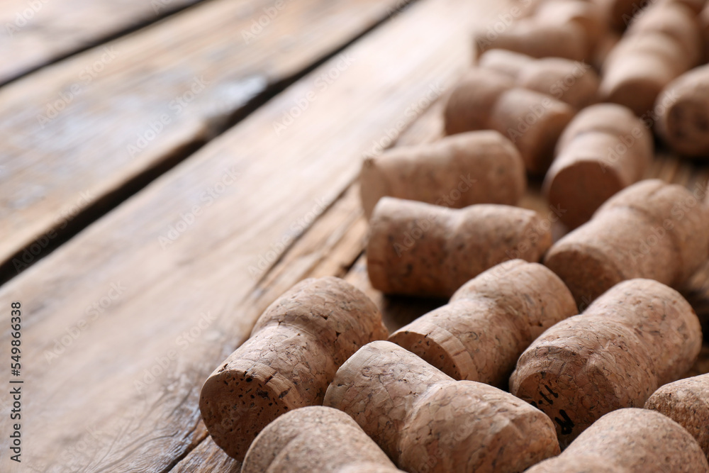 Sparkling wine bottle corks on wooden table, closeup. Space for text Sparkling wine bottle corks on wooden table, closeup. Space for text