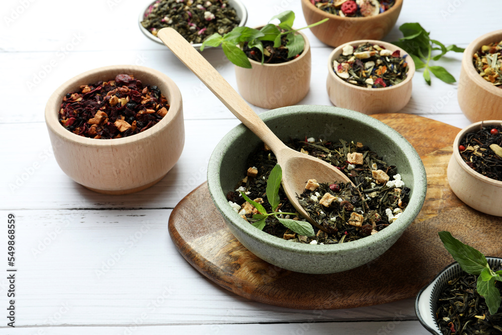 Many different herbal teas on white wooden table