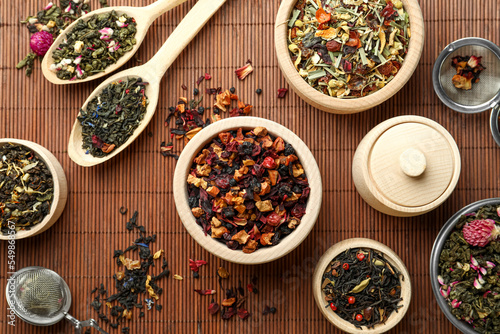 Many different herbal teas on bamboo mat, flat lay