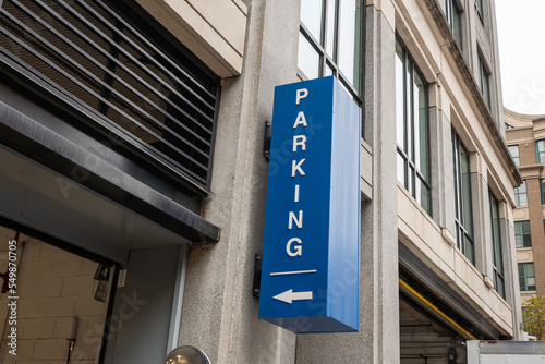 A  blue paid parking garage entrance sign Washington D.C.  Taken on a rainy autumn day.