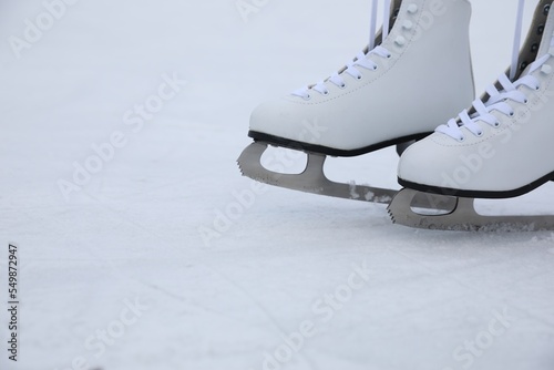 Figure skates with laces on ice, space for text. Winter outdoor activities