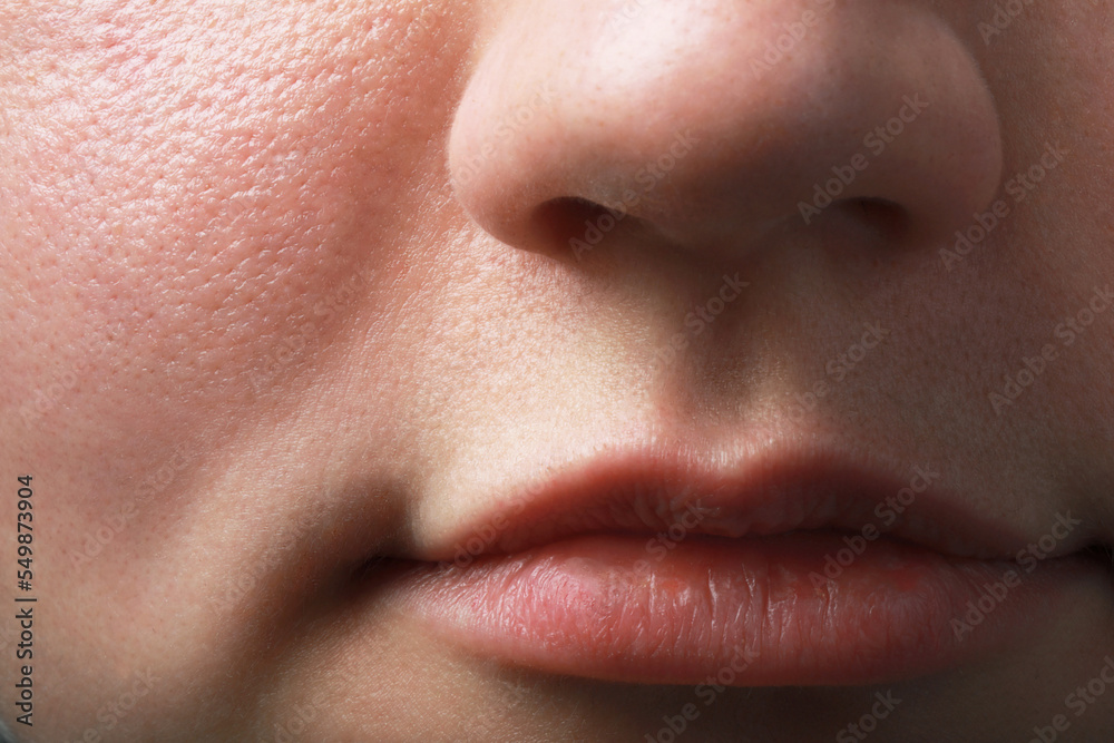 Closeup view of woman with normal skin and beautiful lips Closeup view of woman with normal skin and beautiful lips
