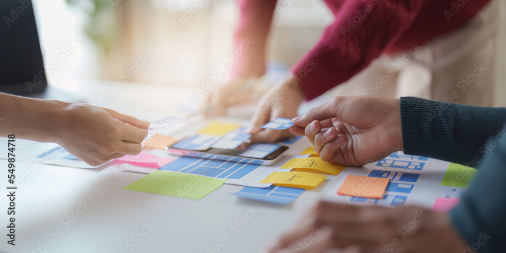 Group of UX UI or designers working to create content of mobile applications. Creative digital development agency concept Group of UX UI or designers working to create content of mobile applications. Creative digital development agency concept