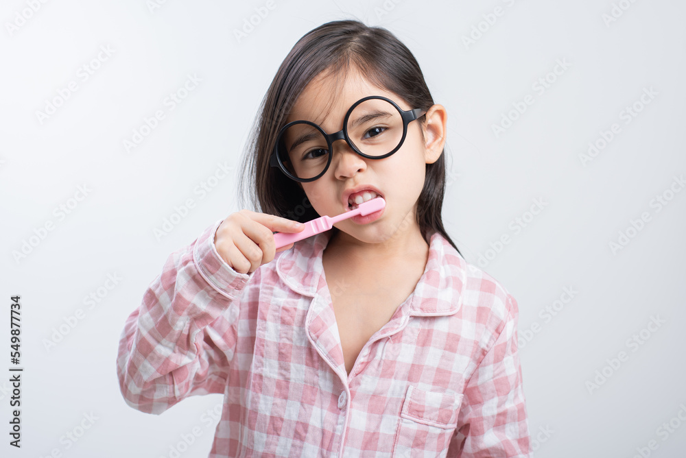 little girl Asia brushing teeth happily white background
