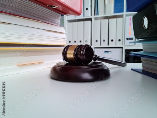 Stack of folders and judge gavel on table