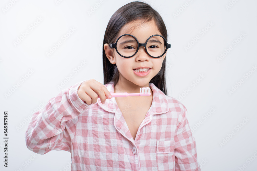 little girl Asia brushing teeth happily white background little girl Asia brushing teeth happily white background