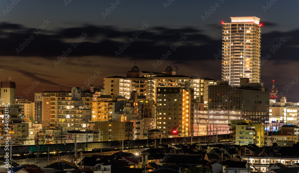 High rise tower over residential buildings in small city after sunset