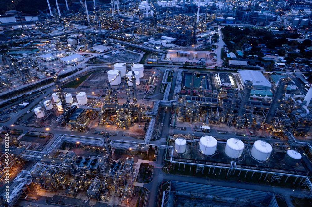 aerial view oil refinery Oil and gas industry, petrochemical plant area and energy concept, oil storage tanks at night time with lights.