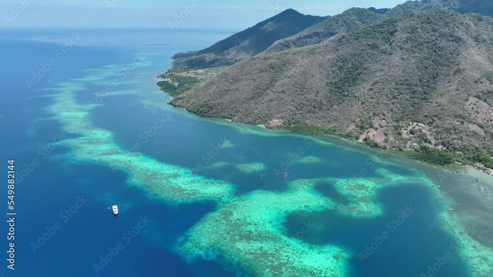 A barrier reef grows off a volcanic island just north of Flores in Indonesia. This beautiful part of the Lesser Sunda Islands is known for its spectacular marine biodiversity. A barrier reef grows off a volcanic island just north of Flores in Indonesia. This beautiful part of the Lesser Sunda Islands is known for its spectacular marine biodiversity.