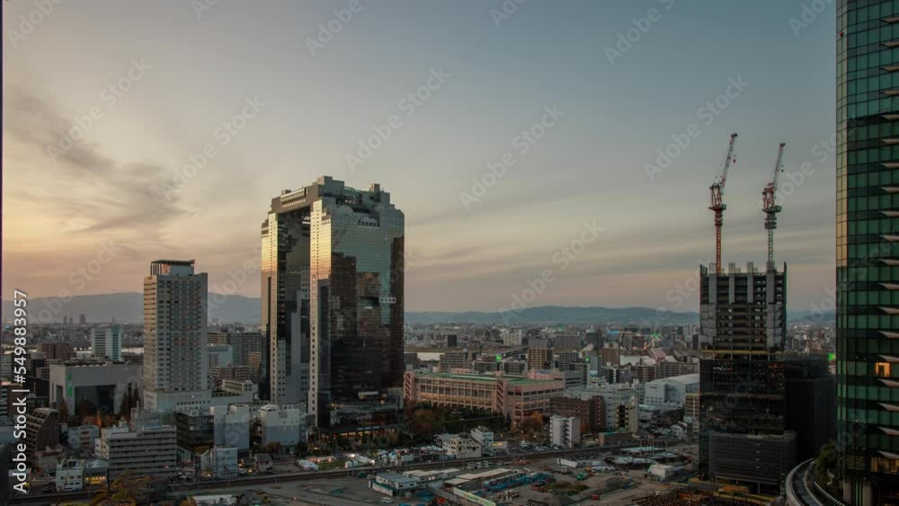 Time Lapse: Sunset over buildings near Osaka Station in Umeda district