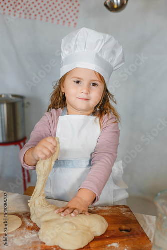 little girl cook in dough cap
