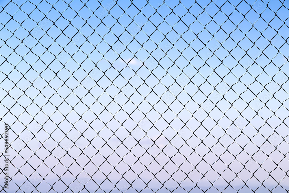 Fototapeta premium Mesh string texture with seamless patterns on bright blue sky background