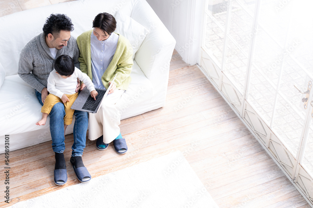 Image of an Asian couple with a cute child in the living room Overhead view no-face