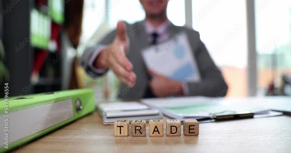 Businessman offers hand for handshake in office text trade Businessman offers hand for handshake in office text trade