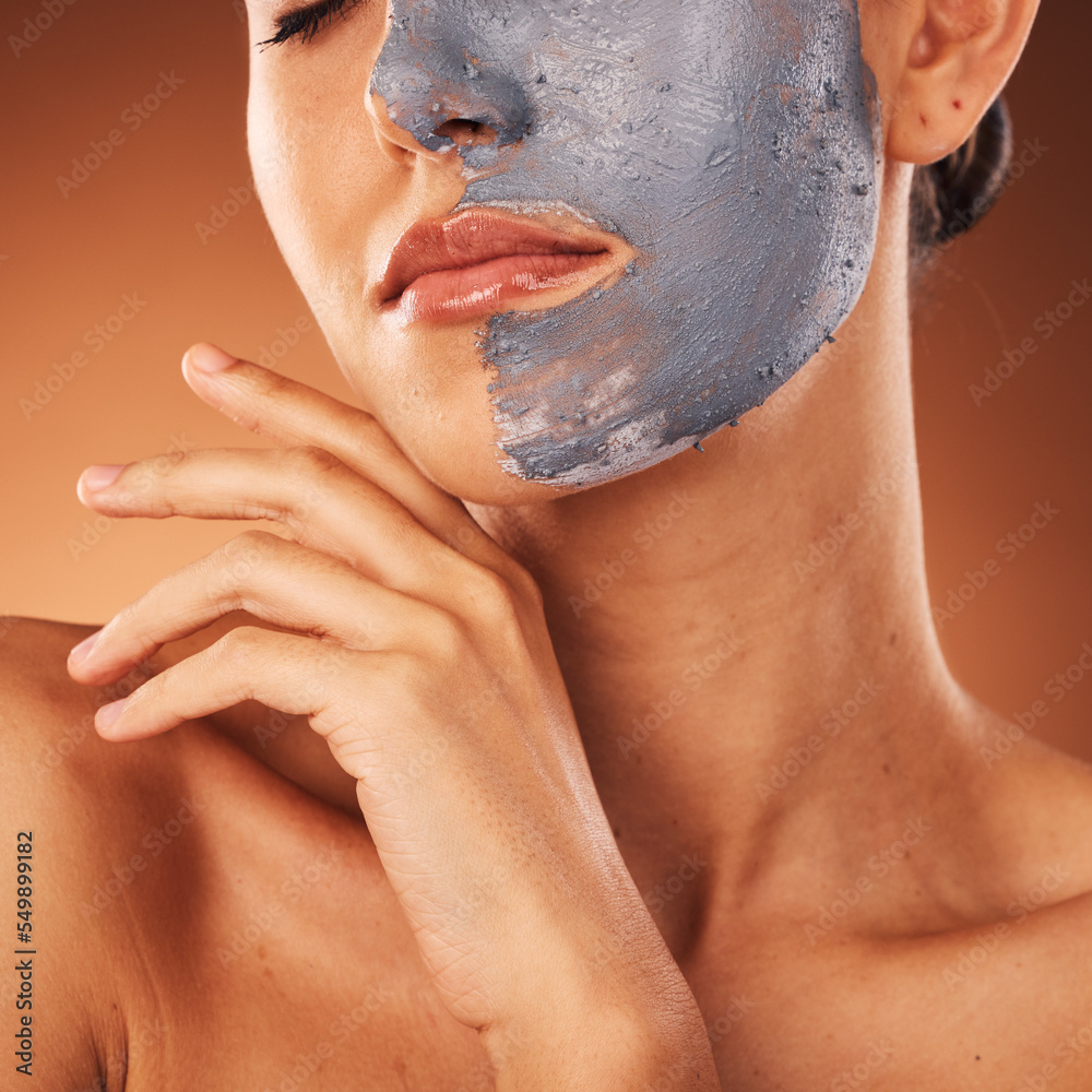 Fototapeta premium Woman, face mask or skincare mud facial on orange studio background in self care, dermatology or acne treatment. Zoom, beauty model or cream product for cleaning, healthcare glow or collagen wellness