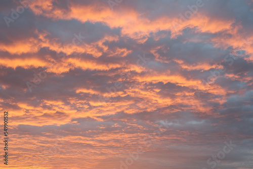 Dramatic sunset or sunrise sky background, red clouds like fire in sky. © atiger