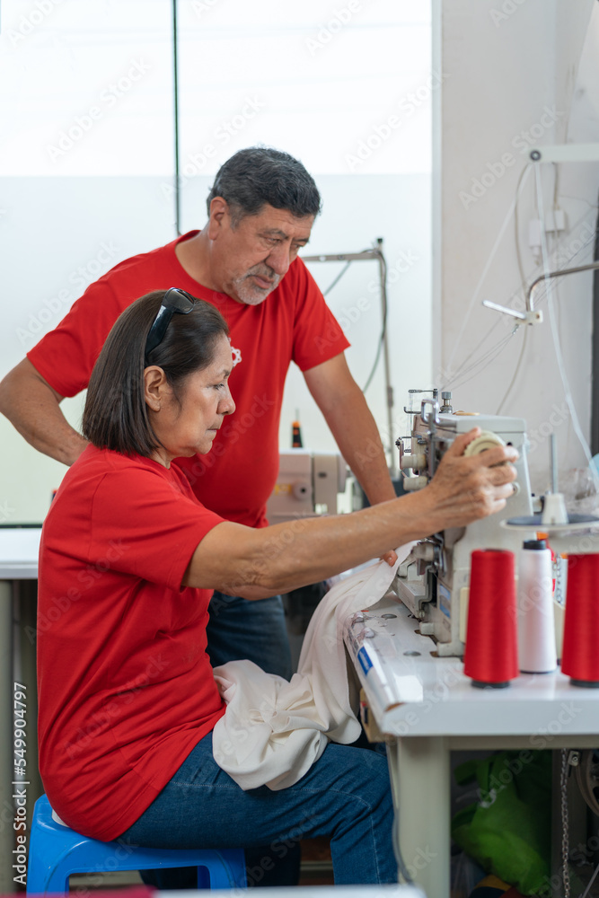 Obraz premium Two people working in a sewing workshop