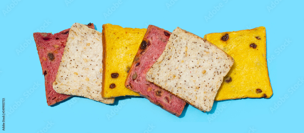 Whole grain bread slices on blue background.