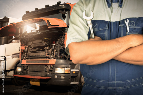 Auto Mechanic Holding A Wrench for Semi Truck Maintenance. Checking the Truck's Safety. Repairman Service Shop. Inspection Safety Driving.