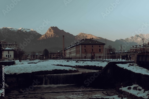 View of buildings surrounded by mountains in Feltre