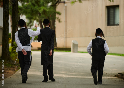 Hasidic jewish boys walking down the street in williamsburg brooklyn. 