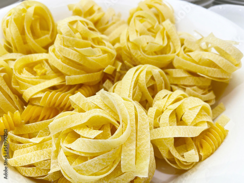 Uncooked Italian pasta tagliatelle nest
