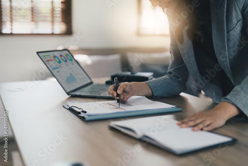 Financial analyst analyzes business people investment consultant analyzing company financial report working with documents graphs. Stock Market Tax Fund Finance concept. © itchaznong