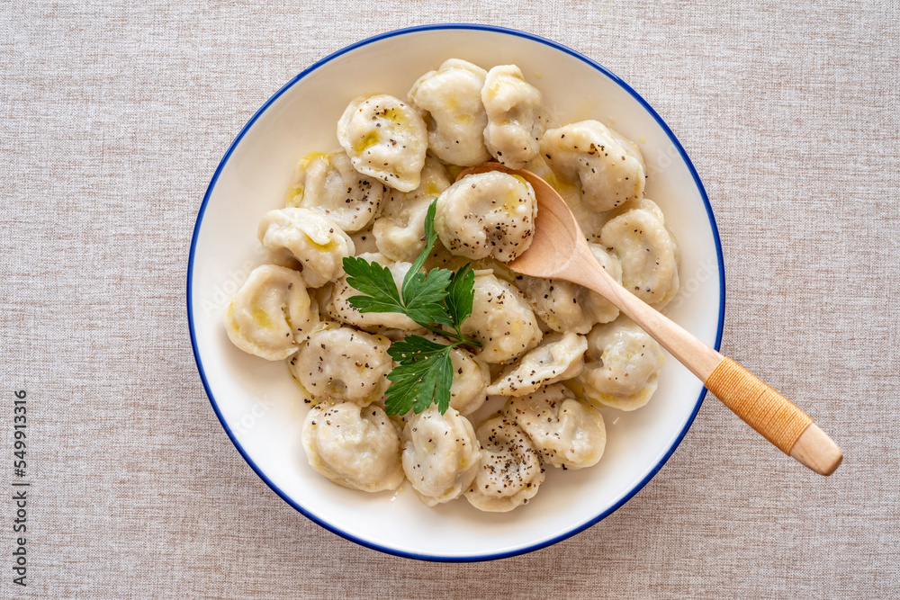 Plate with dumplings on cotton fabric background. Plate with dumplings on cotton fabric background.
