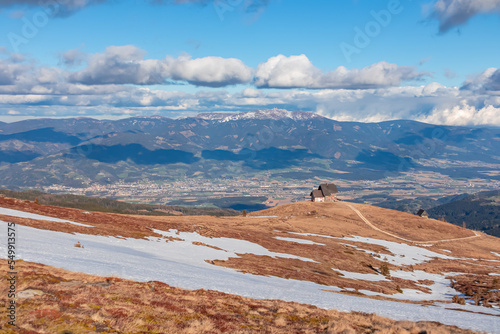 Panoramic view of mountain hut Wolfsbergerhuette (Wolfsberger Huette) on Saualpe, Lavanttal Alps, Carinthia, Austria, Europe. Alpine road leading to remote cottage. Panorama on Wolfsberg and Koralpe photo