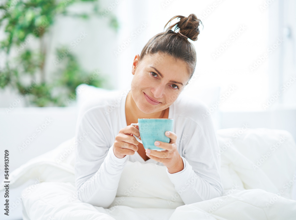 Young nice woman in bed with coffee or tea mug Young nice woman in bed with coffee or tea mug