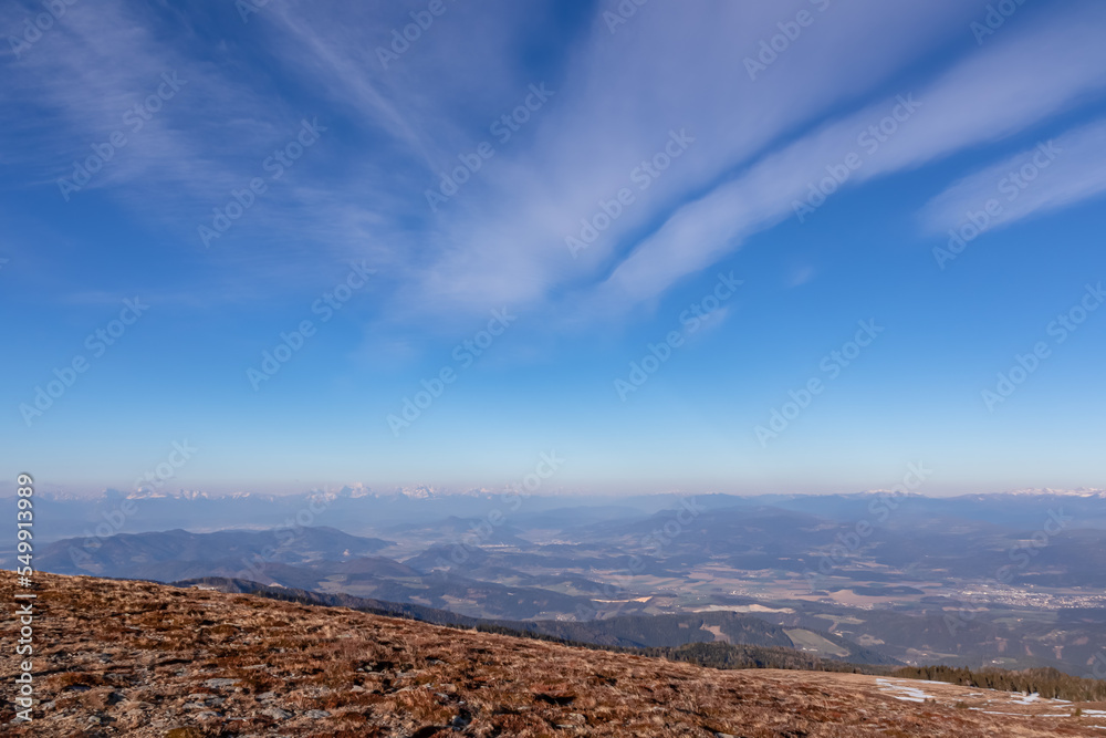 Scenic view of alpine meadows and Karawanks mountains at sunrise seen from Ladinger Spitz, Saualpe, Lavanttal Alps, Carinthia, Austria, Europe. Hiking trails at morning golden hour in Wolfsberg region