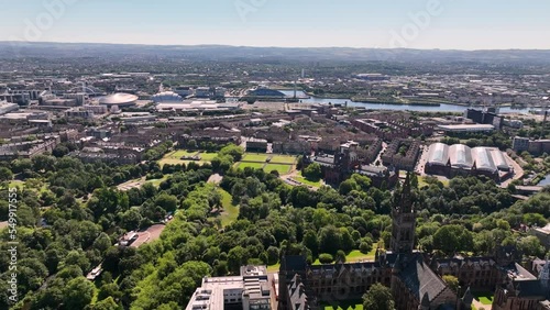 Aerial shot of Kelvingrove Park and Glasgow University panning left to see city skyline and Park Circus on a sunny day photo