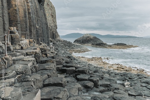 Fingal Cave surrounded by rocks and water photo