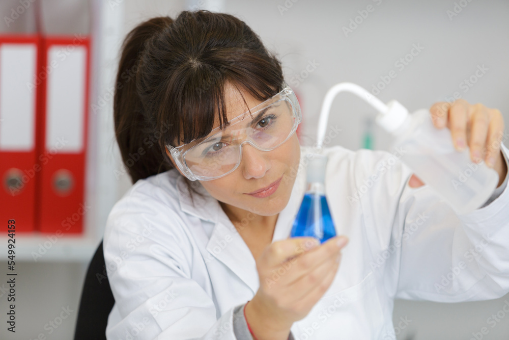 female tech works in chemical lab female tech works in chemical lab