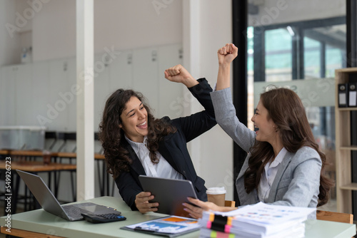 Two happy friendly diverse professionals, cheerful successful business partners colleagues giving hand bumb celebrating business triumph in office photo