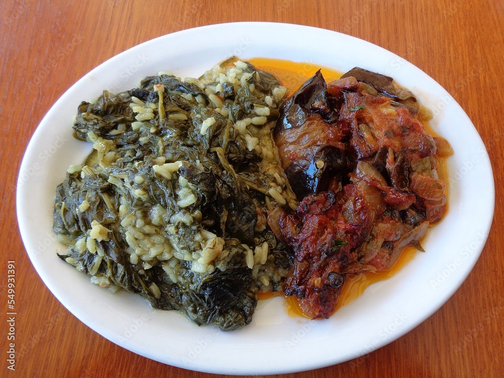 Spinach with rice and eggplant pieces with tomato sauce dish Spinach with rice and eggplant pieces with tomato sauce dish