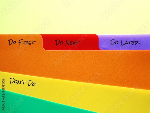 Document folder with tags labels DO FIRST DO NEXT DO LATER DON'T DO, concept of time management skills, knowing priority of tasks, difference between important and urgent tasks