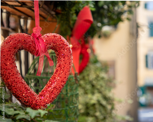 Christmas decoration in the shape of a red heart hanging on the streets as an ornament of the holidays.