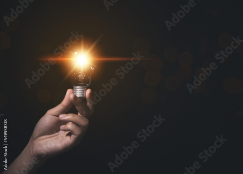 businessman holding a light bulb Digital technology. imagine an idea Creative and innovative.