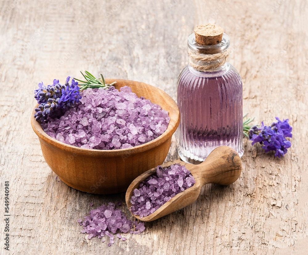 Lavender salt and flavored water on wooden backgrounds. Lavender salt and flavored water on wooden backgrounds.