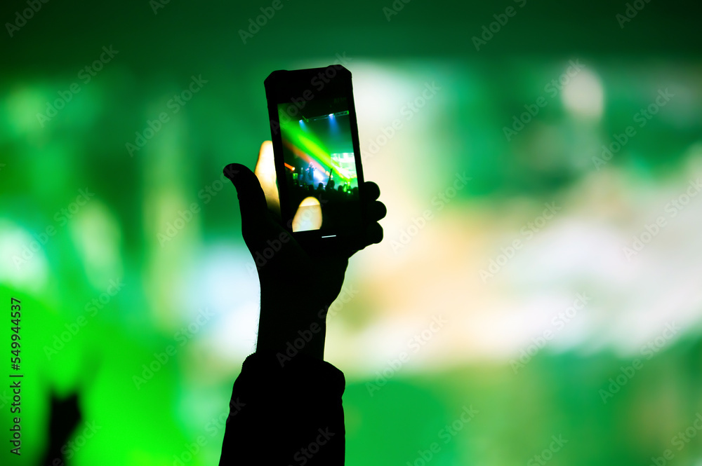 Video and photo recording of the Color music concert by smartphone. Beach party.
