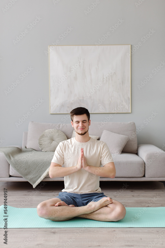 A young man practices yoga in the studio. yoga class. High quality photo A young man practices yoga in the studio. yoga class. High quality photo