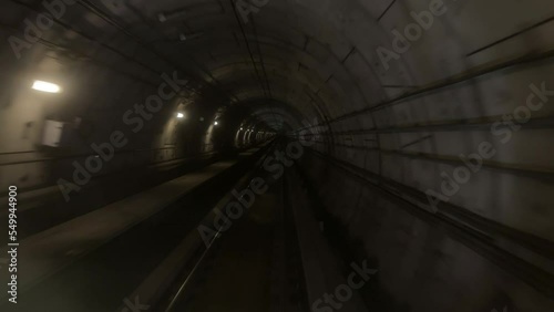 Underground dark subway metro rail train mrt running moving through the tunnel from one station to another station