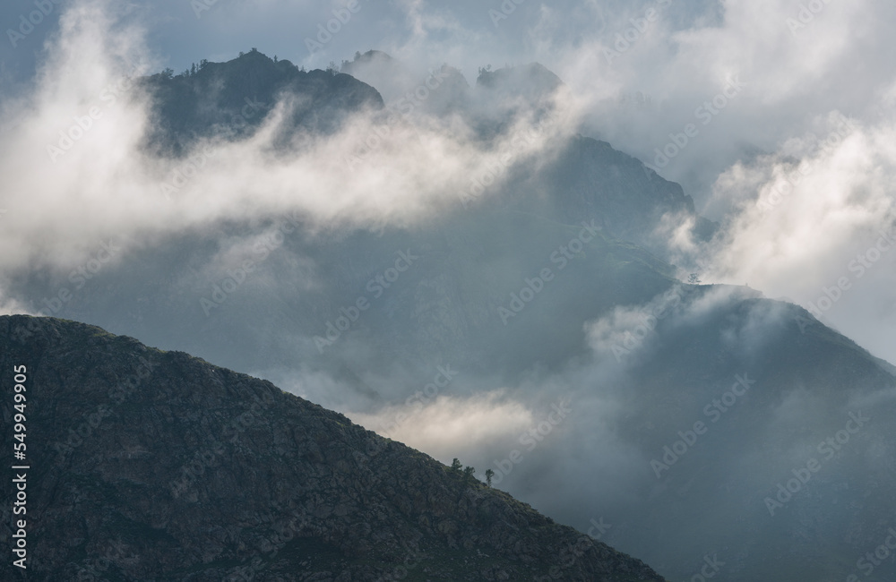 Mountain peaks in the clouds, foggy morning
