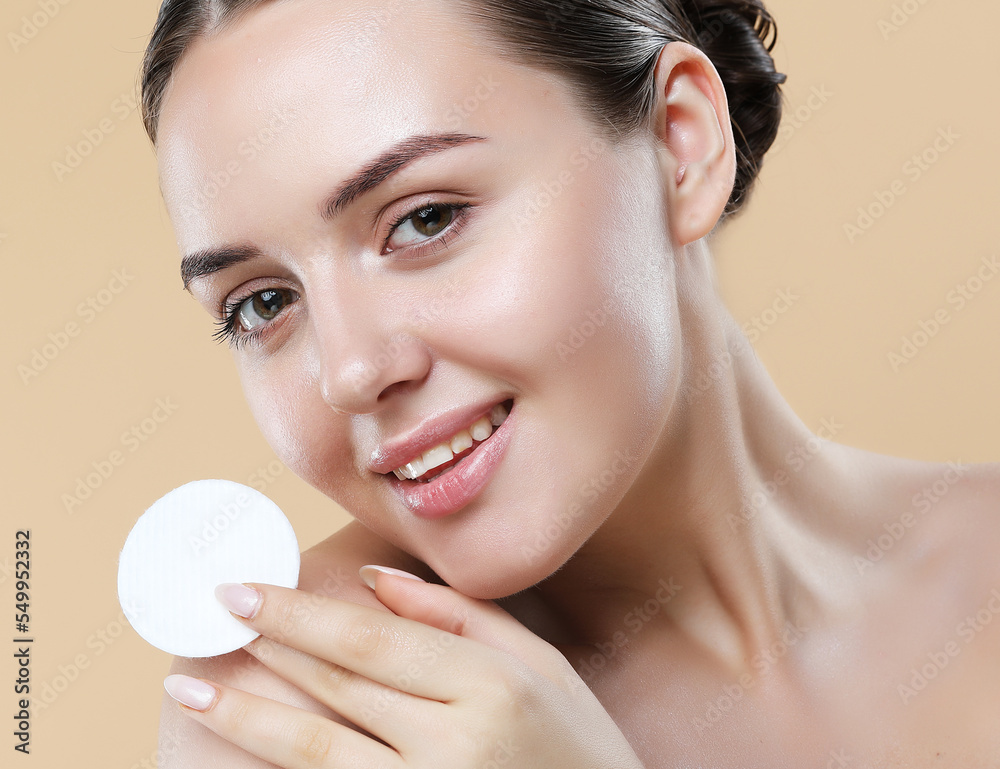 Beauty female model cleansing her perfect skin by cotton pad sponge, close-up. Beauty female model cleansing her perfect skin by cotton pad sponge, close-up.