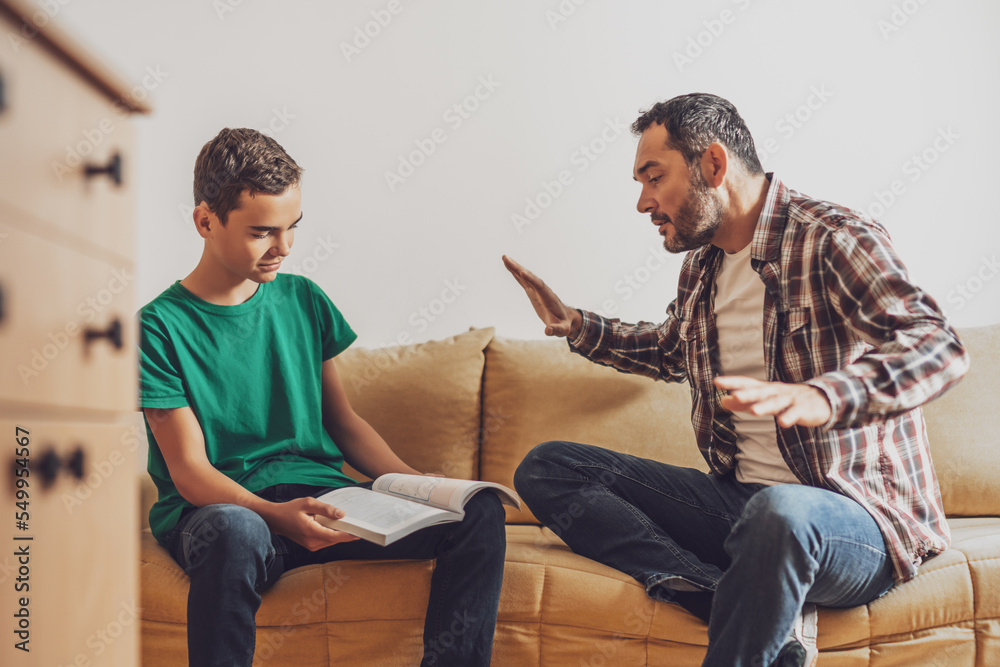 Father is helping his son with learning. Boy is having problem with homework.