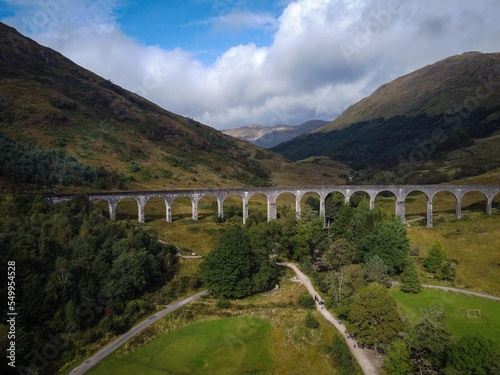 Scenic aerial view of Glenfinnan viaduct with train by autumn, Scotland